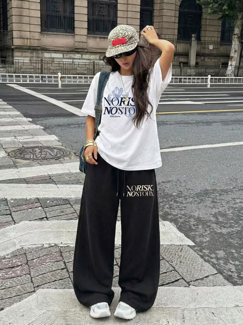 "NO RISK, NO STORY" Oversized Streetwear Set – White Drop-Shoulder Graphic Tee & Black Wide-Leg Trousers