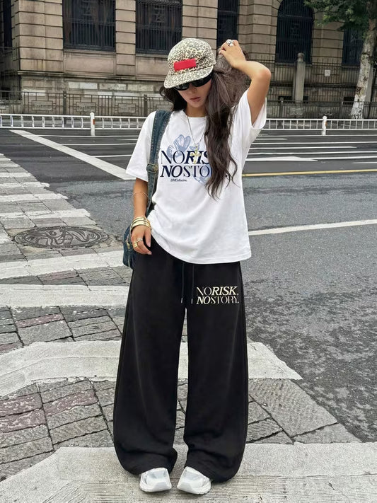 "NO RISK, NO STORY" Oversized Streetwear Set – White Drop-Shoulder Graphic Tee & Black Wide-Leg Trousers